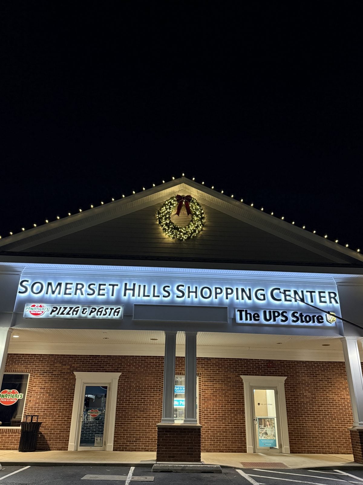 The Somerset Hills Shopping Center with its roofline and gable outlined in warm light