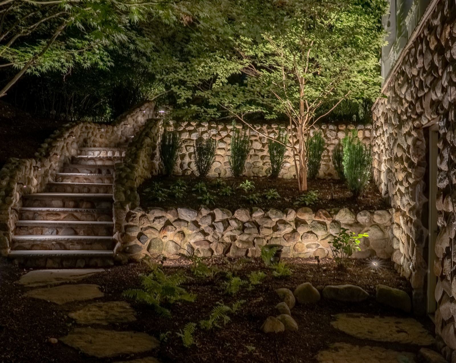 Hardscape lighting washing stone treads and the wall they are cut into