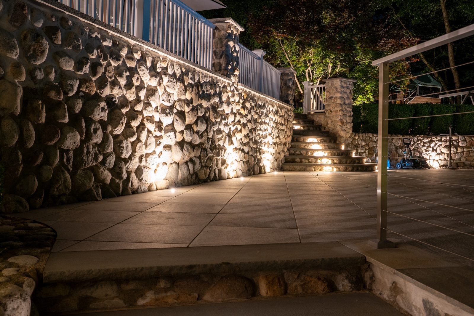 Steps and a retaining wall lit low, the route up reading clearly after dark