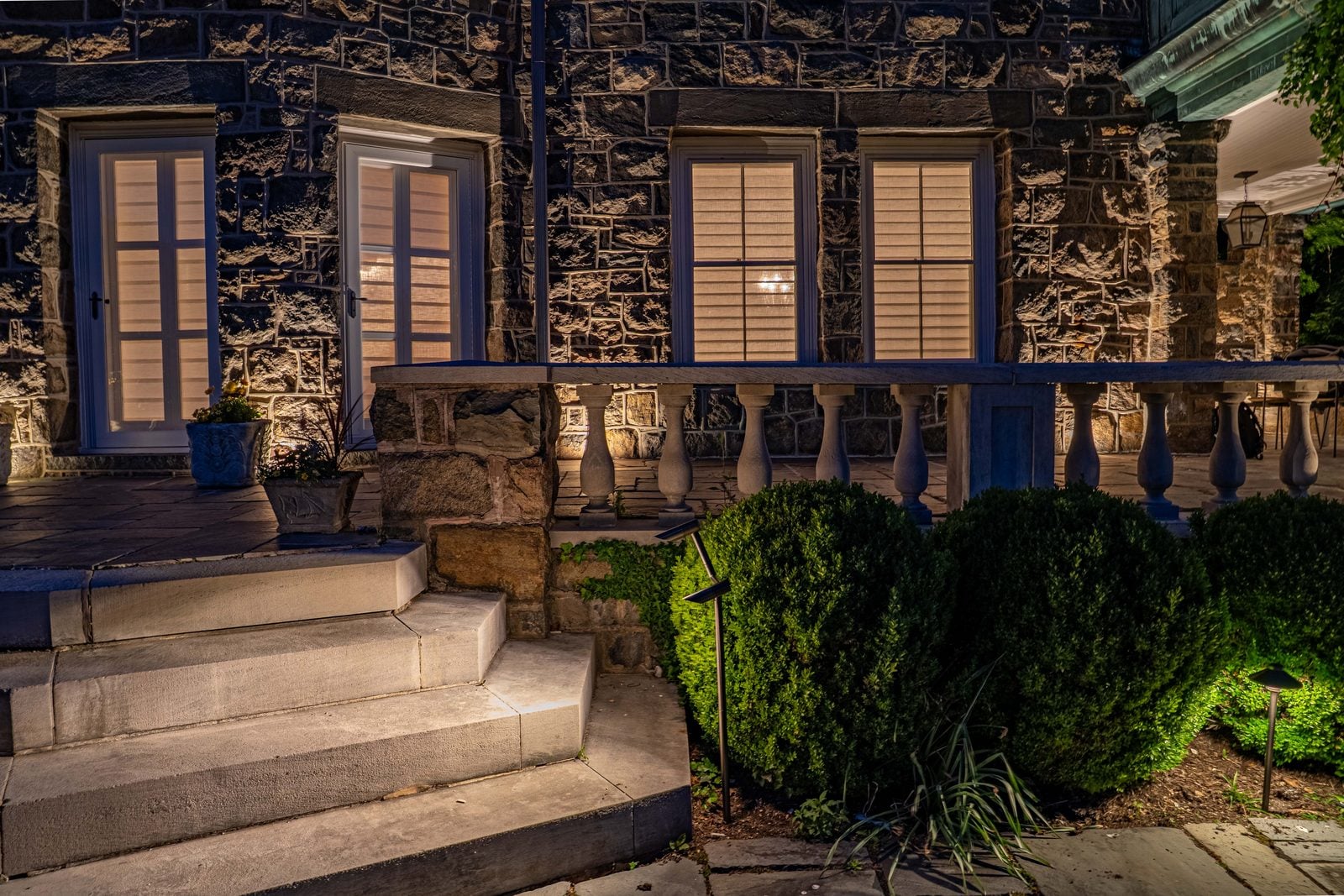 Stone steps lit tread by tread from fixtures set into the wall beside them