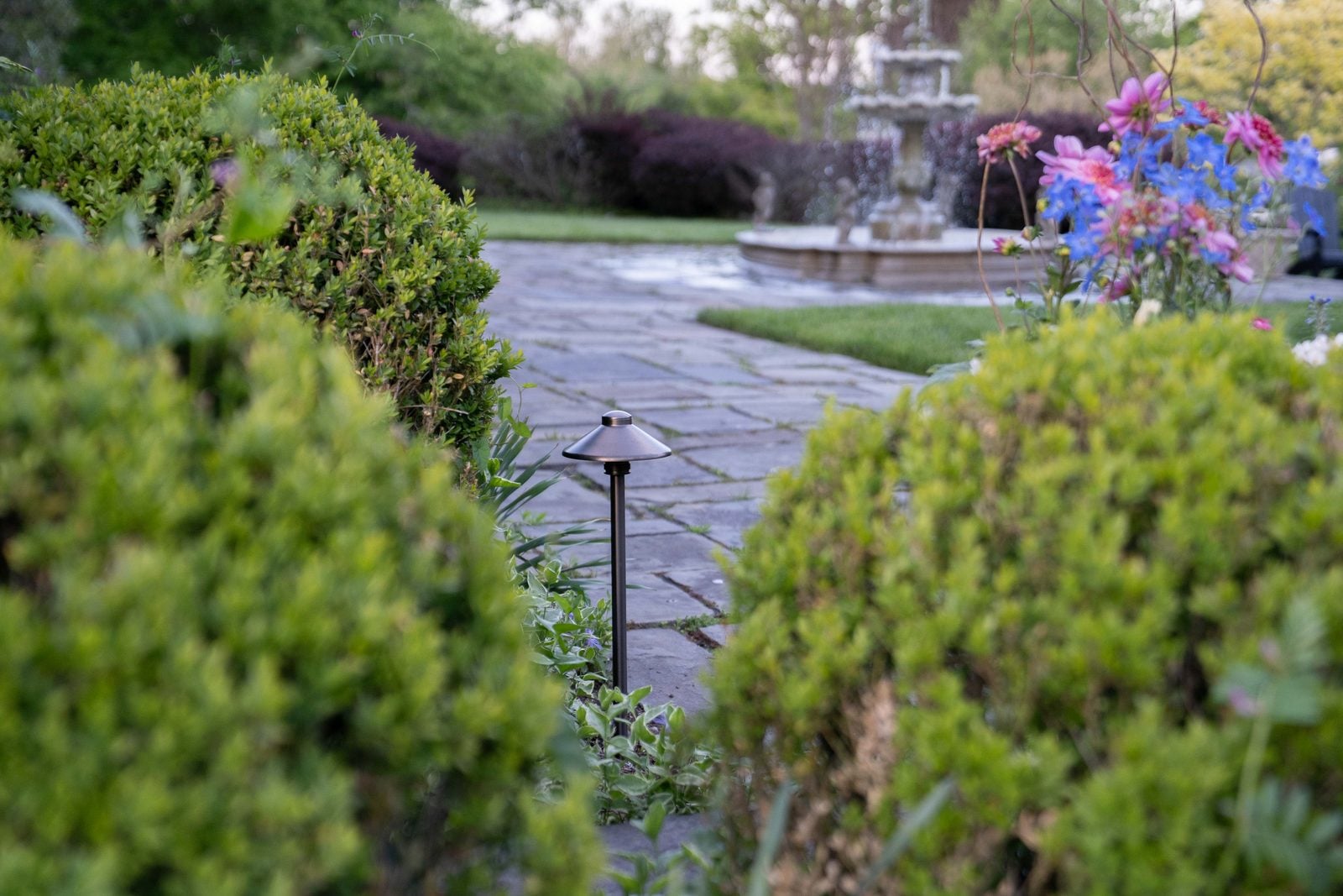 Steps and a retaining wall lit low, the route up reading clearly after dark