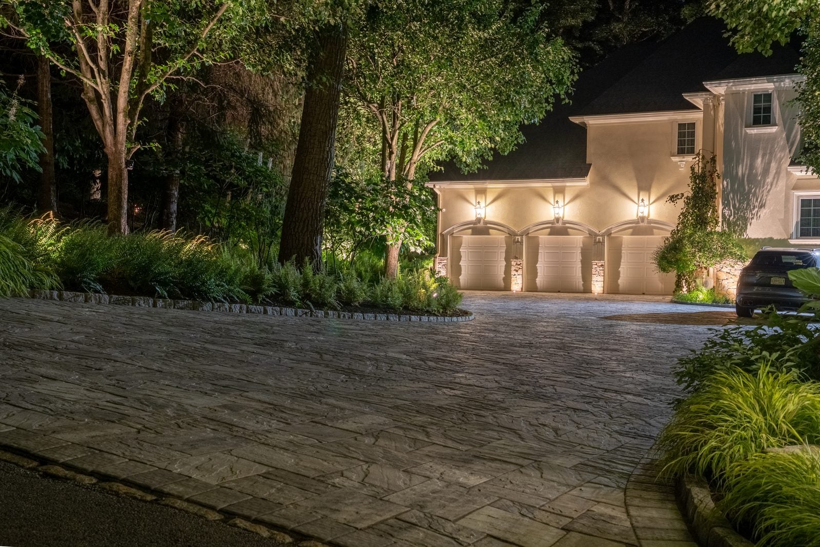 Warm light grazing the front of a home, gables and stonework brought forward