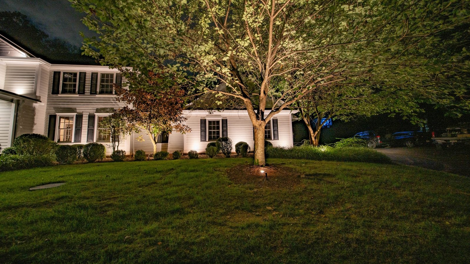Warm light grazing the front of a home, gables and stonework brought forward