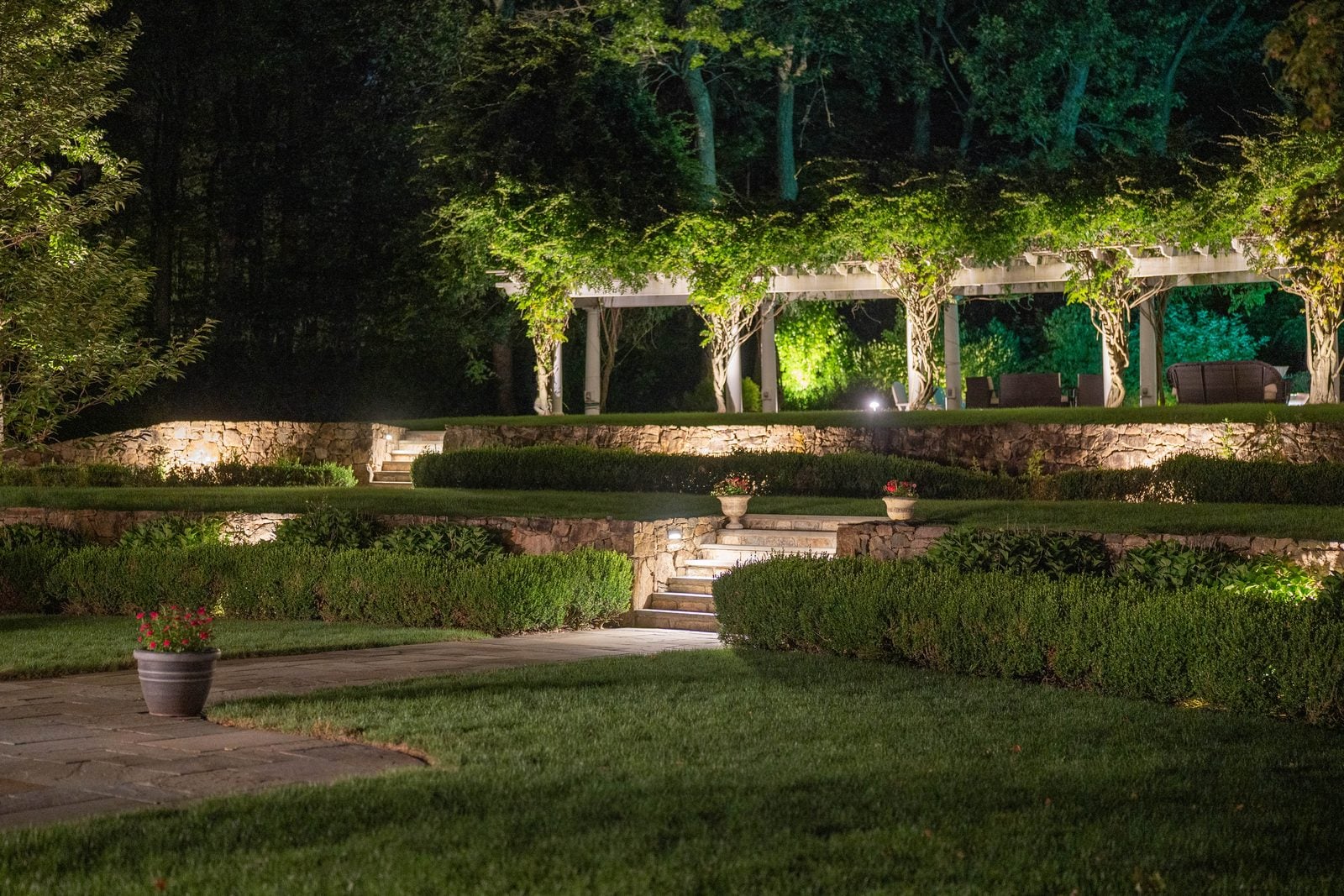Steps and a retaining wall lit low, the route up reading clearly after dark