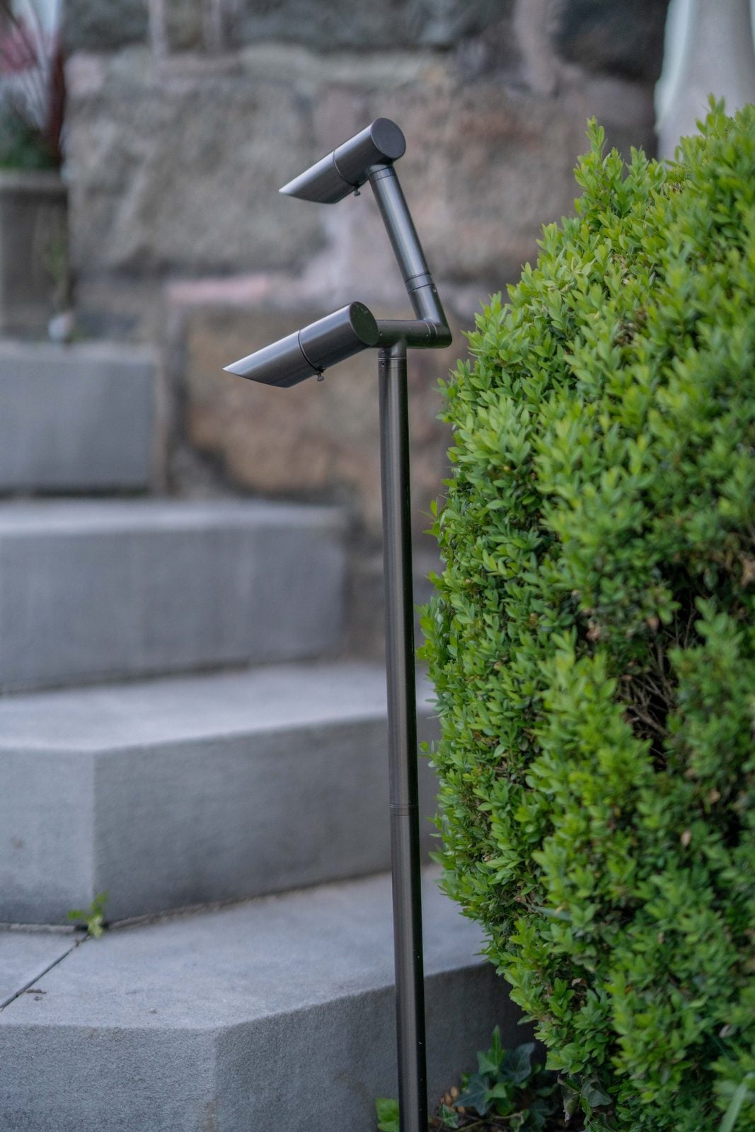 A close view of a landscape fixture in place, mounted and aimed